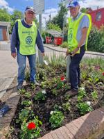 2024-2025 President Charles House, and Friend of Rotary Roy Thompson planting flowers at Uckfield Railway Station